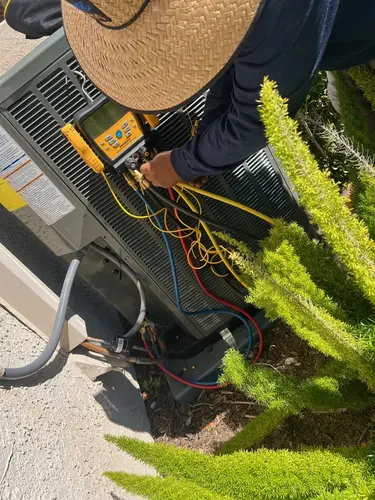 HVAC professional handling R-454B refrigerant installation for a modern energy-efficient cooling system